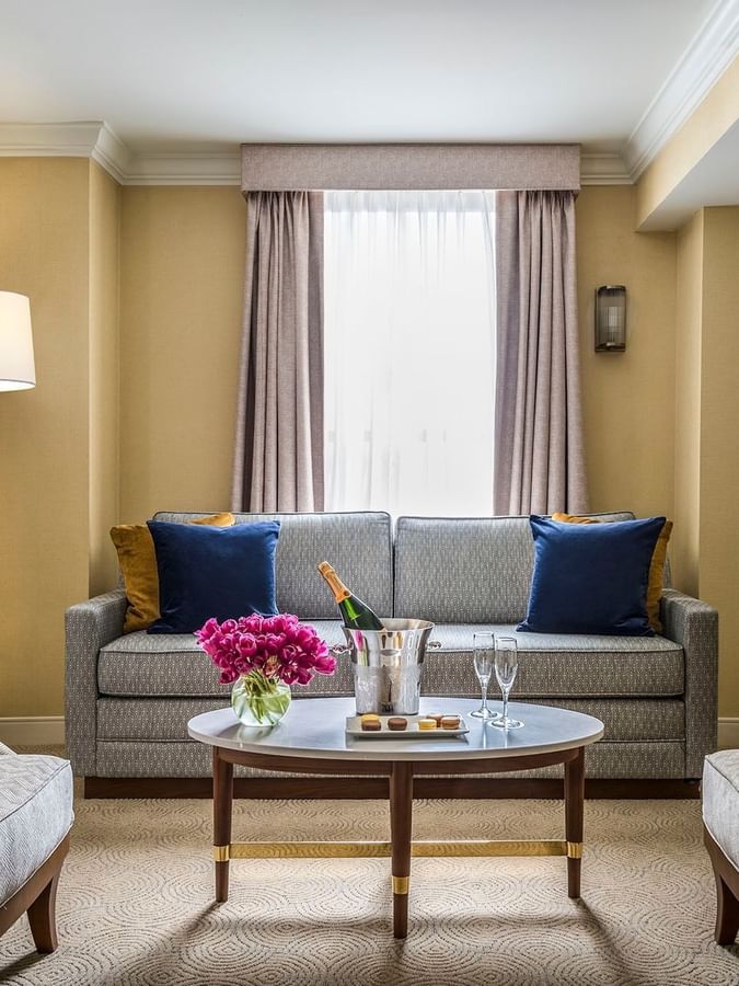 Executive King living area with a sofa & coffee table near window at Warwick Allerton Chicago