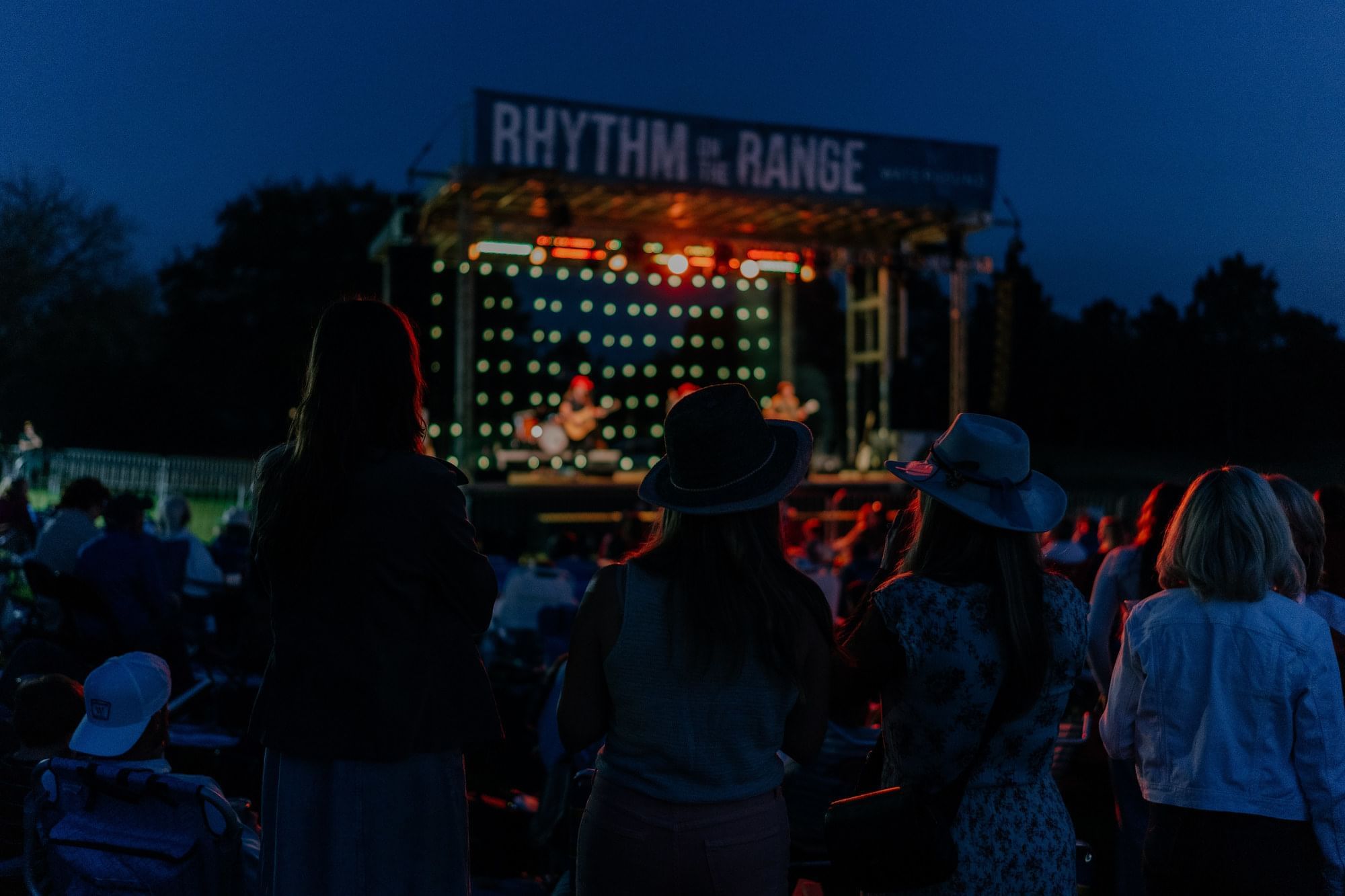 People are watching a live music concert titled 