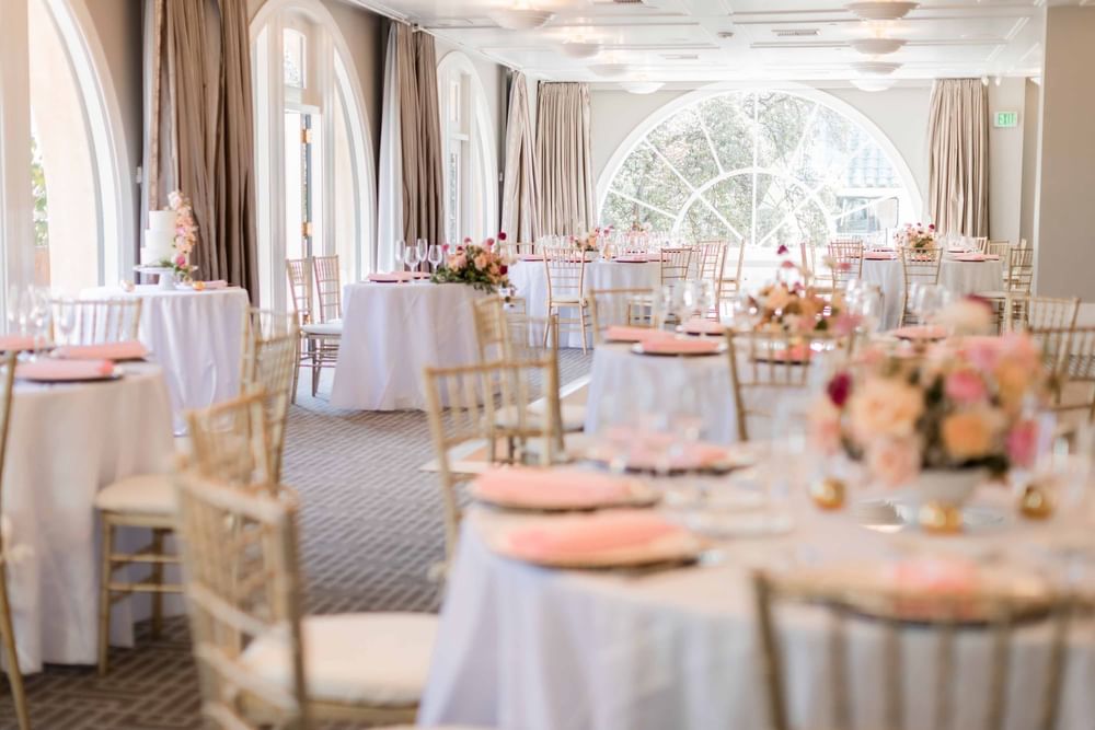 Ballroom with set up banquets and floral decor at El Prado Hotel