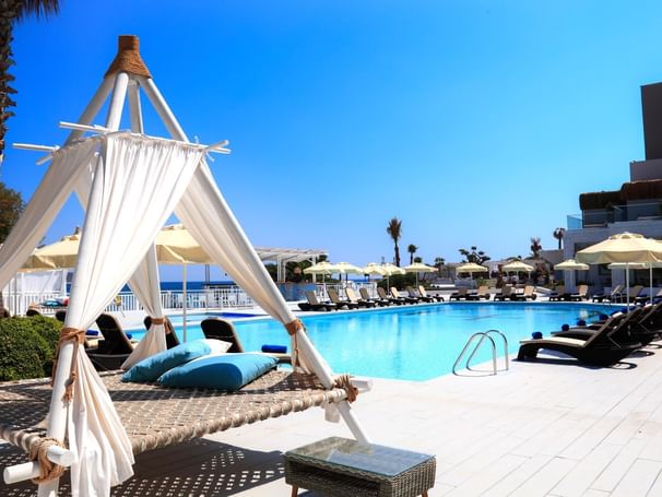 Pool area with pool chairs at Design Plus Seya Beach Hotel