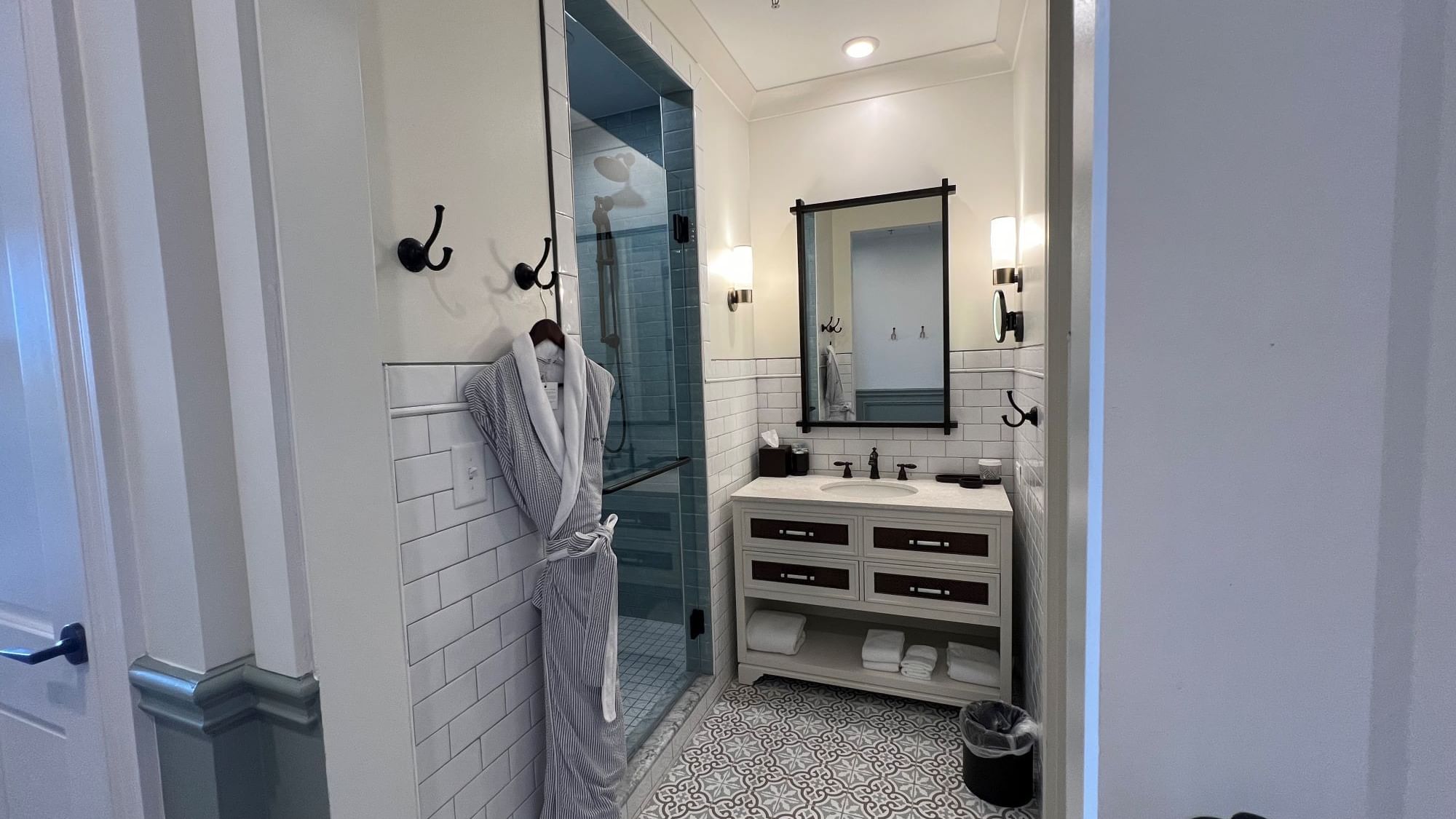 Bathroom vanity & shower area in Pine Suite with a bathrobe at Camp Creek Inn