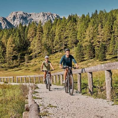A couple Mountain Biking near Falkensteiner Hotels