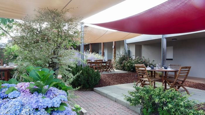 A Dining area by the patio at Hotel Le Logis d'Elbee