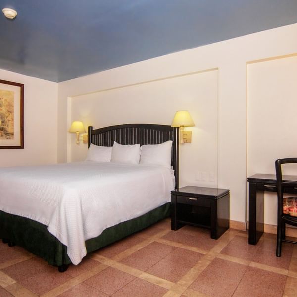 Large bed & desk in the Superior Room at Gamma Hotels