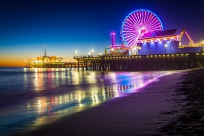 Santa Monica Pier lit up at dusk
