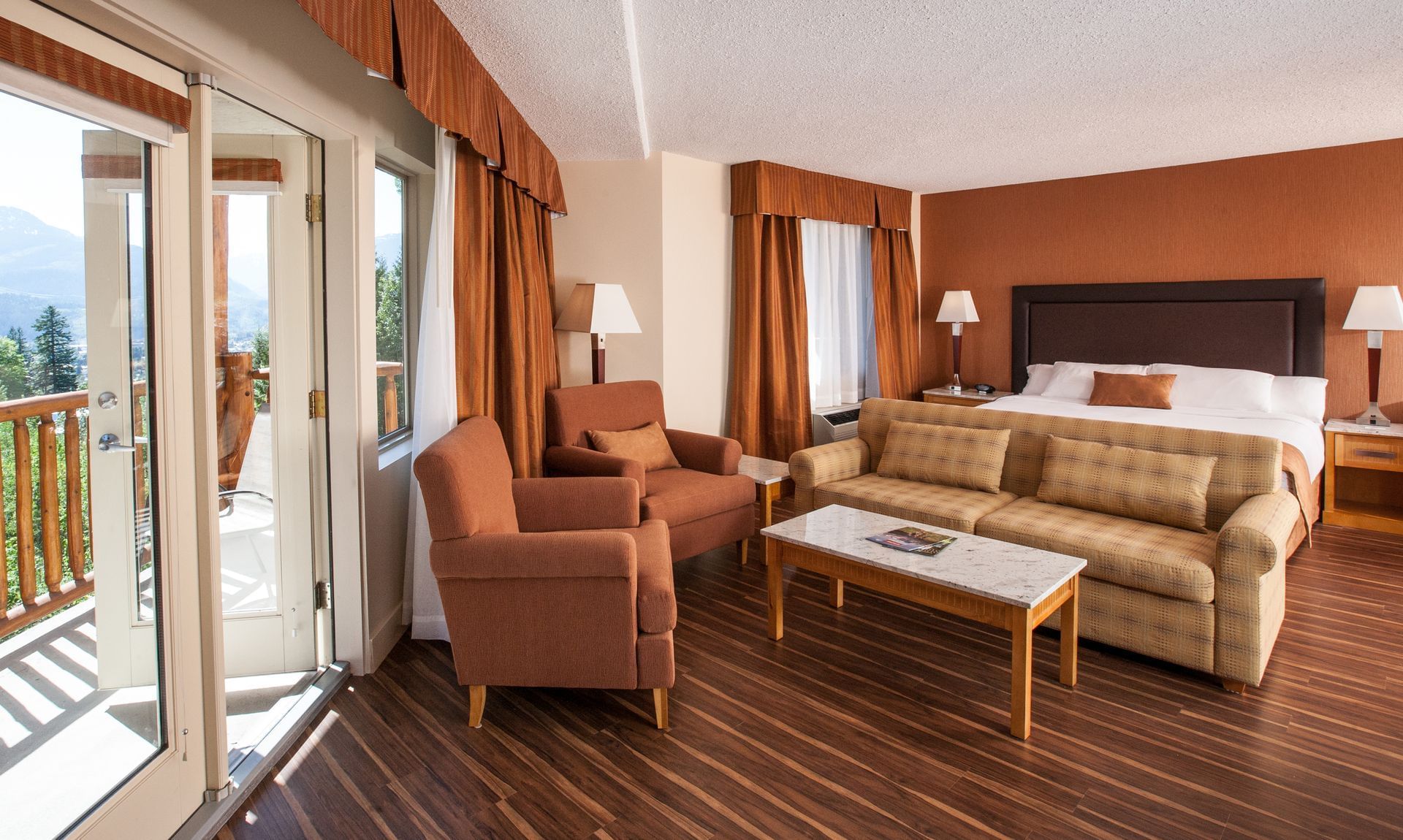 Bed, sofa and balcony in hotel room