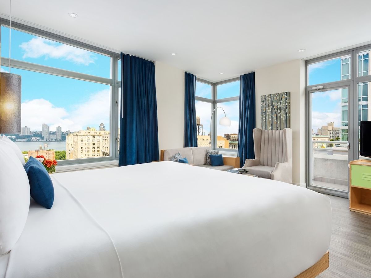 a bed and chair in a hotel room
