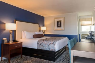 Nightstand & work desk by the bed in a cozy Room with carpeted floors at Union Bluff Hotel