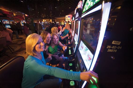 Ladies playing arcade games in a casino near Pearl River Resort