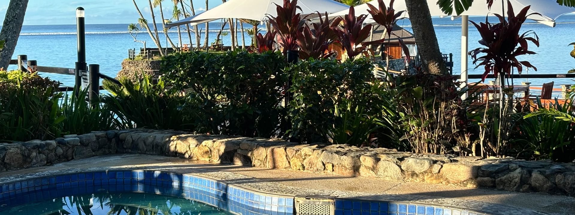 Blue-tiled swimming pool with ocean view at Warwick Fiji Resort and Spa in Korolevu