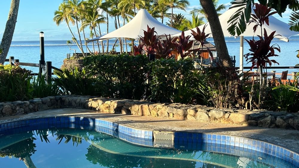 Blue-tiled swimming pool with ocean view at Warwick Fiji Resort and Spa in Korolevu.