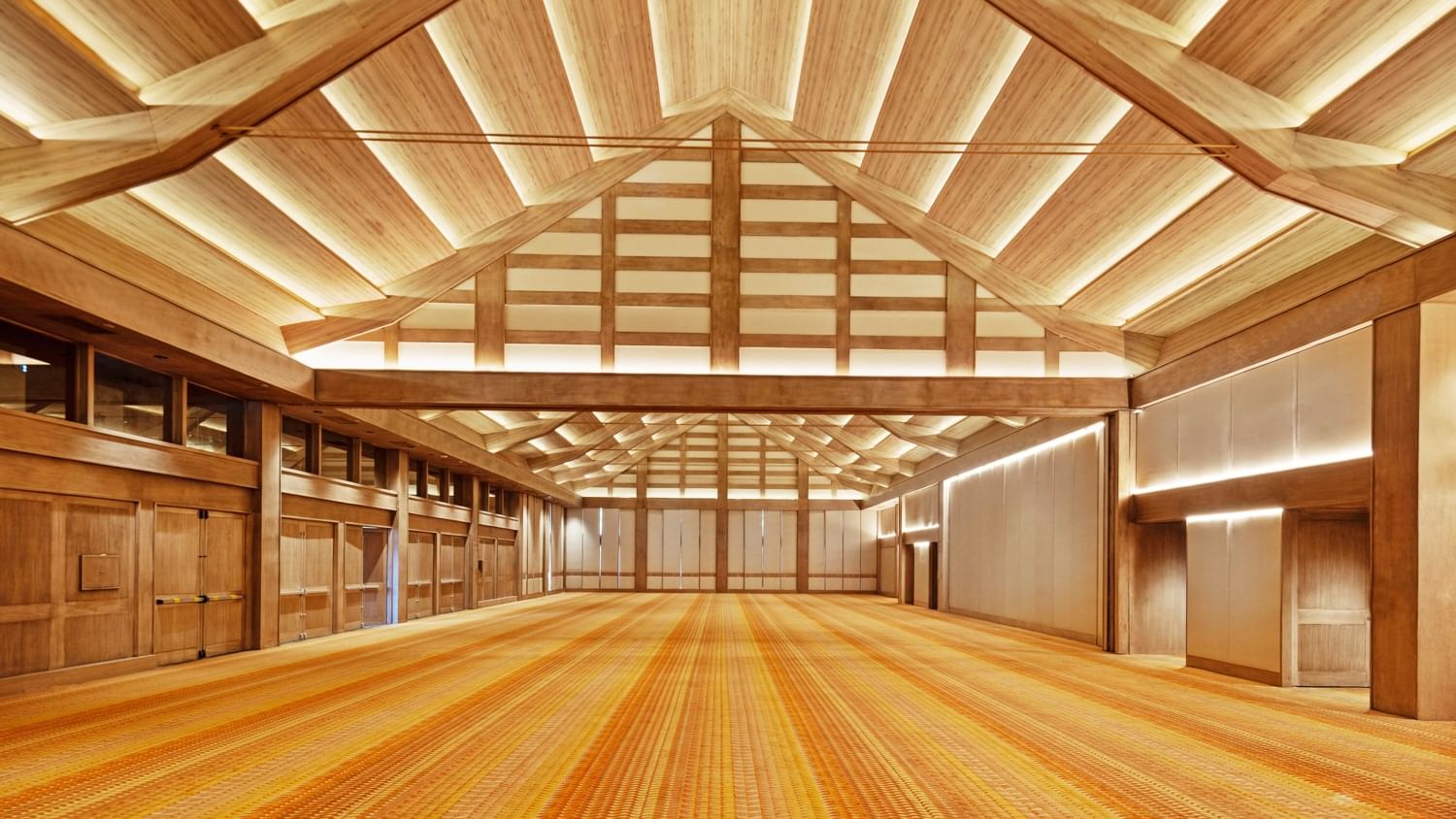Wooden beams and orange carpeted floor of a large empty hall at Grand Fiesta Americana Sumiya Cuernavaca.