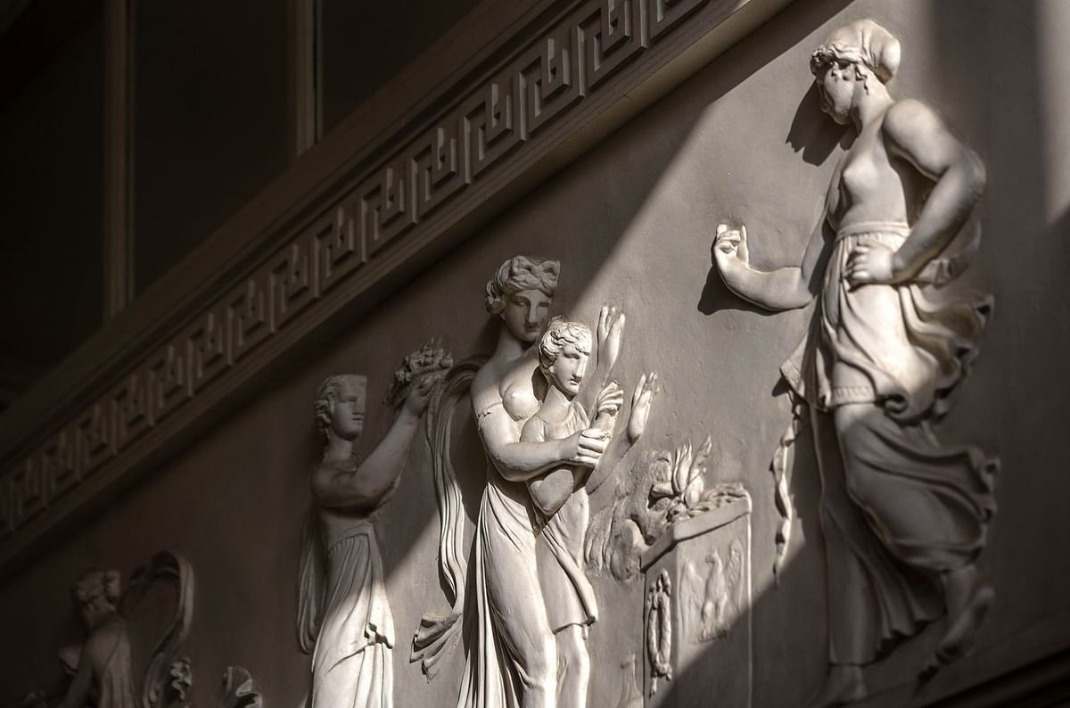 Classical Greek-style white stone relief sculpture on a lounge wall at Hotel Barsey by Warwick