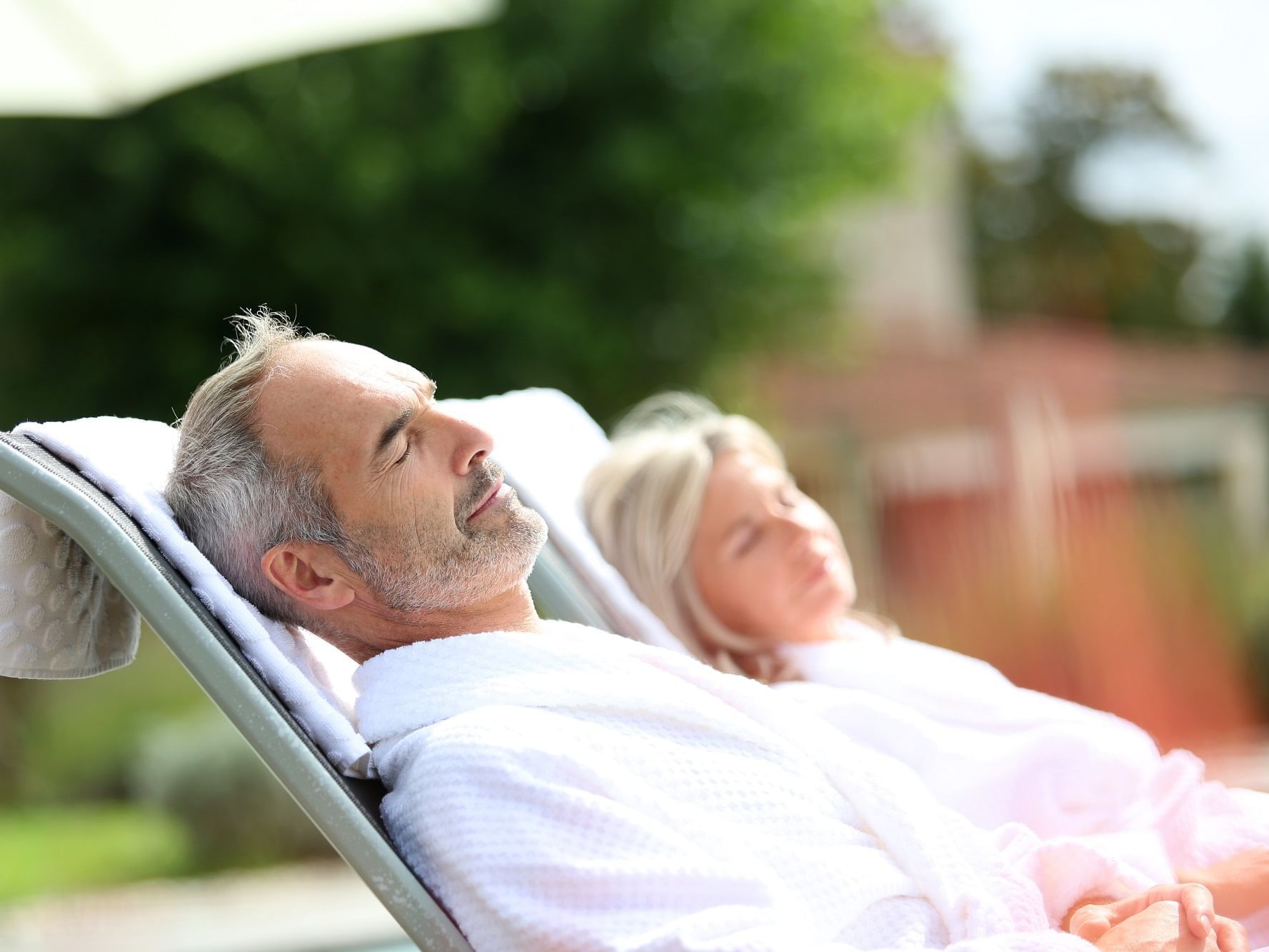 Senior couple relaxing on the sun beds at Originals Hotels