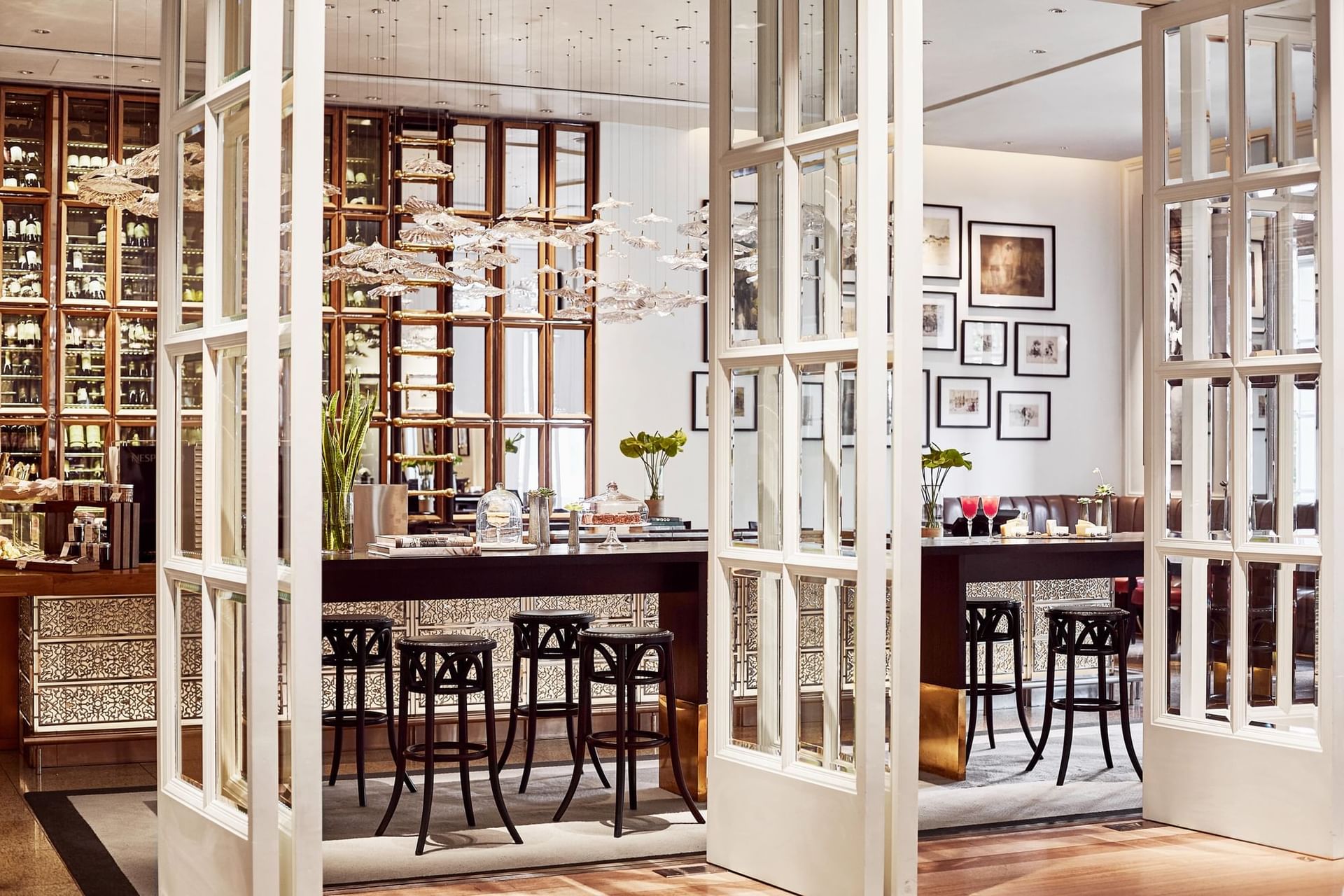 Opera entrance with glass doors revealing modern interior, bar, and plush seating at Park Hyatt Saigon