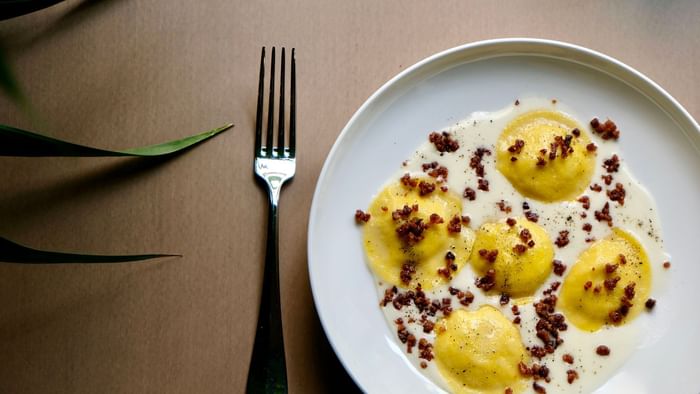 Overhead view of an omelet served with a set of cutlery at Da Mariolino Restaurant