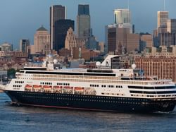 Cruise ship docked in a bustling city near Hotel Zero1