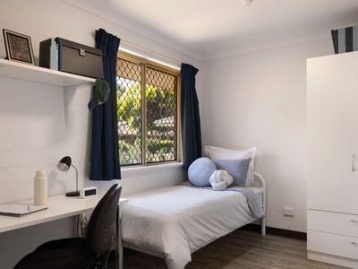 Bedroom with bed, desk, chair, and wardrobe at UniLodge at Curtin University Vickery House.