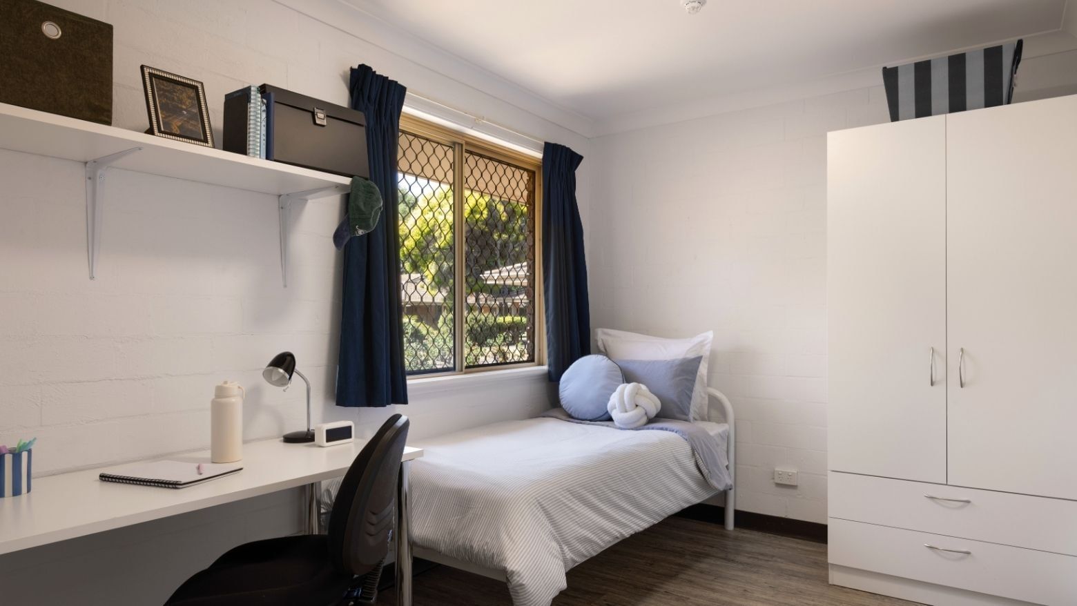 Bedroom with bed, desk, chair, and wardrobe at UniLodge at Curtin University Vickery House.