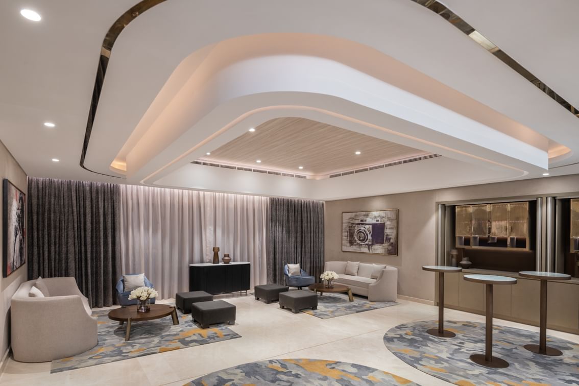 Business Studio 2 at Paramount Hotel Midtown with stylish seating, elegant lighting, and modern decor with textured curtains