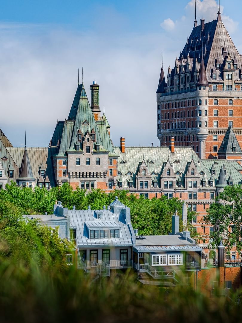 Scenic historic city castle view with green roof spires in Château Frontenac near Warwick Le Crystal Montreal