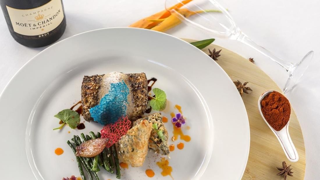 Meal served on a white plate with chilli powder in Lagoon Terrace Restaurant at Warwick Le Lagon 