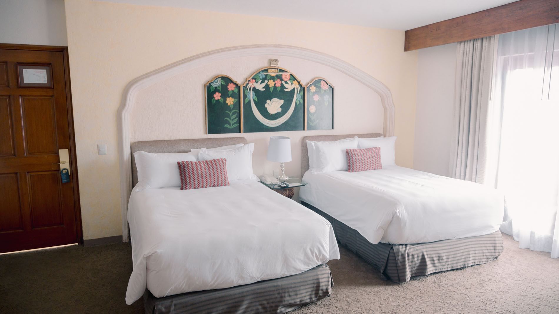 2 Double Master Suite with white linens and colorful pillows at Quinta Real Zacatecas
