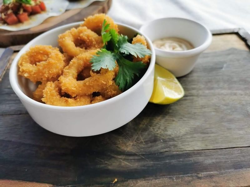 Close-up of Onion rings served at Naay Tulum Curamoria