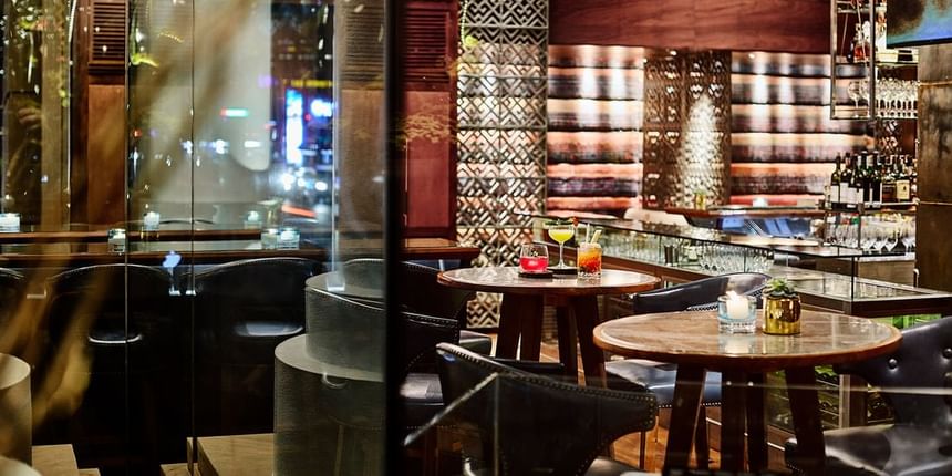2 Lam Son interior with elegant lighting, wooden tables, and colorful cocktails on display at Park Hyatt Saigon