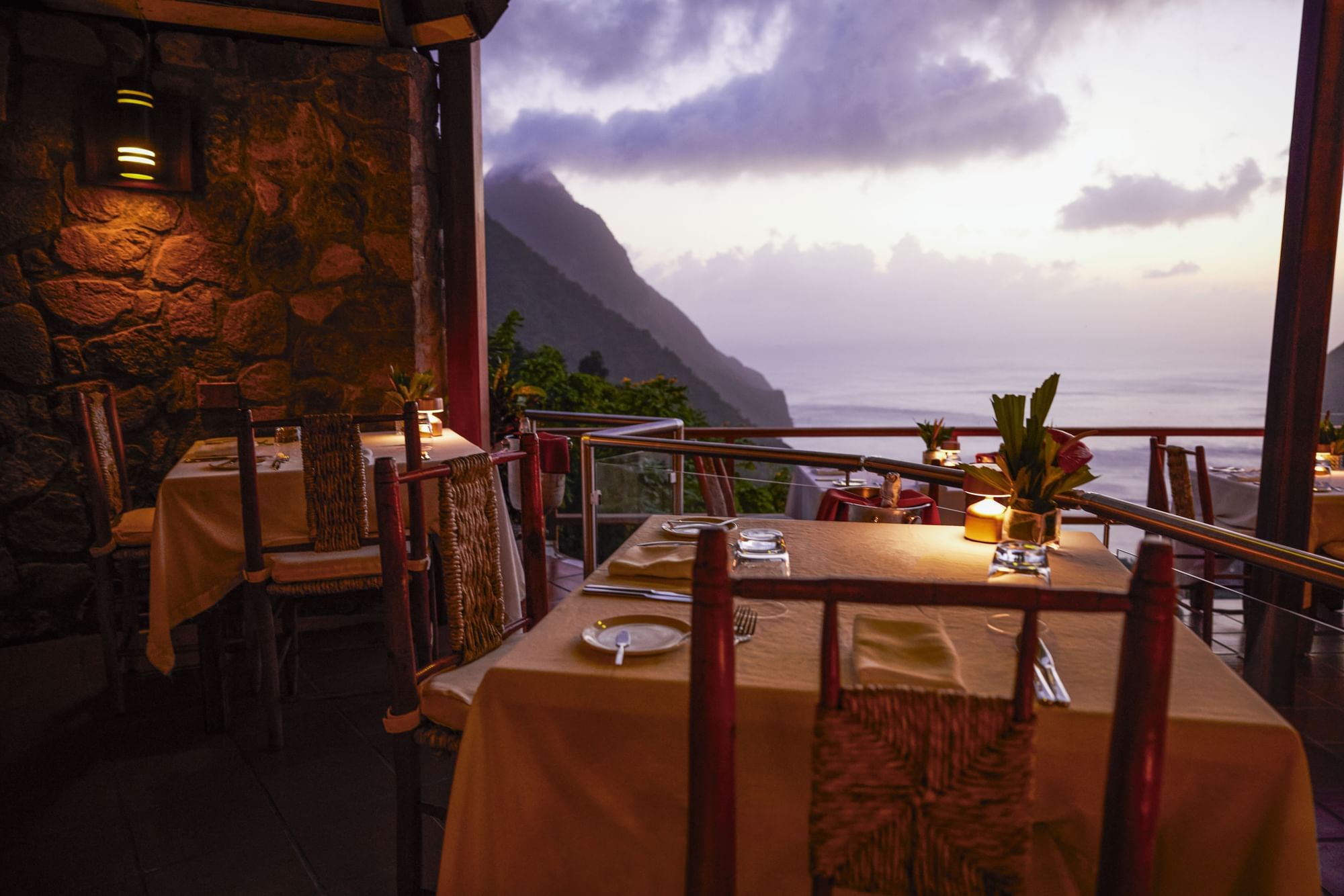 Dining tables are arranged on the balcony in Dasheene Restaurant at Ladera Resort