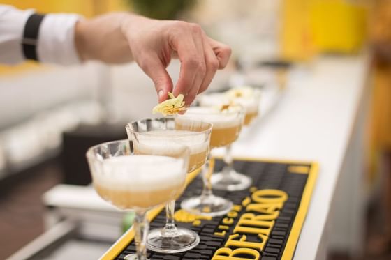 Bartender making drinks by the bar counter at Oliver Like Home