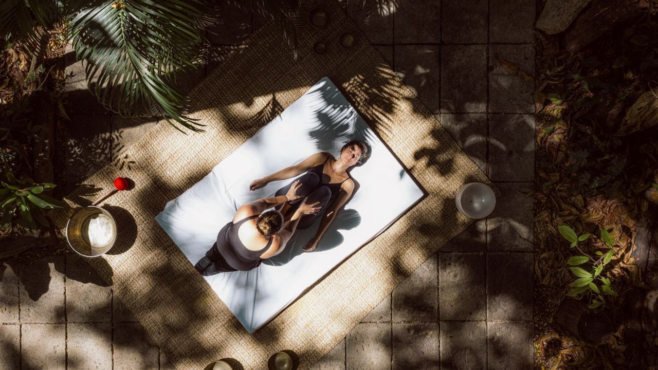 Overhead view of a relaxing massage session on a sunny patio at Cala Luna Boutique Hotel