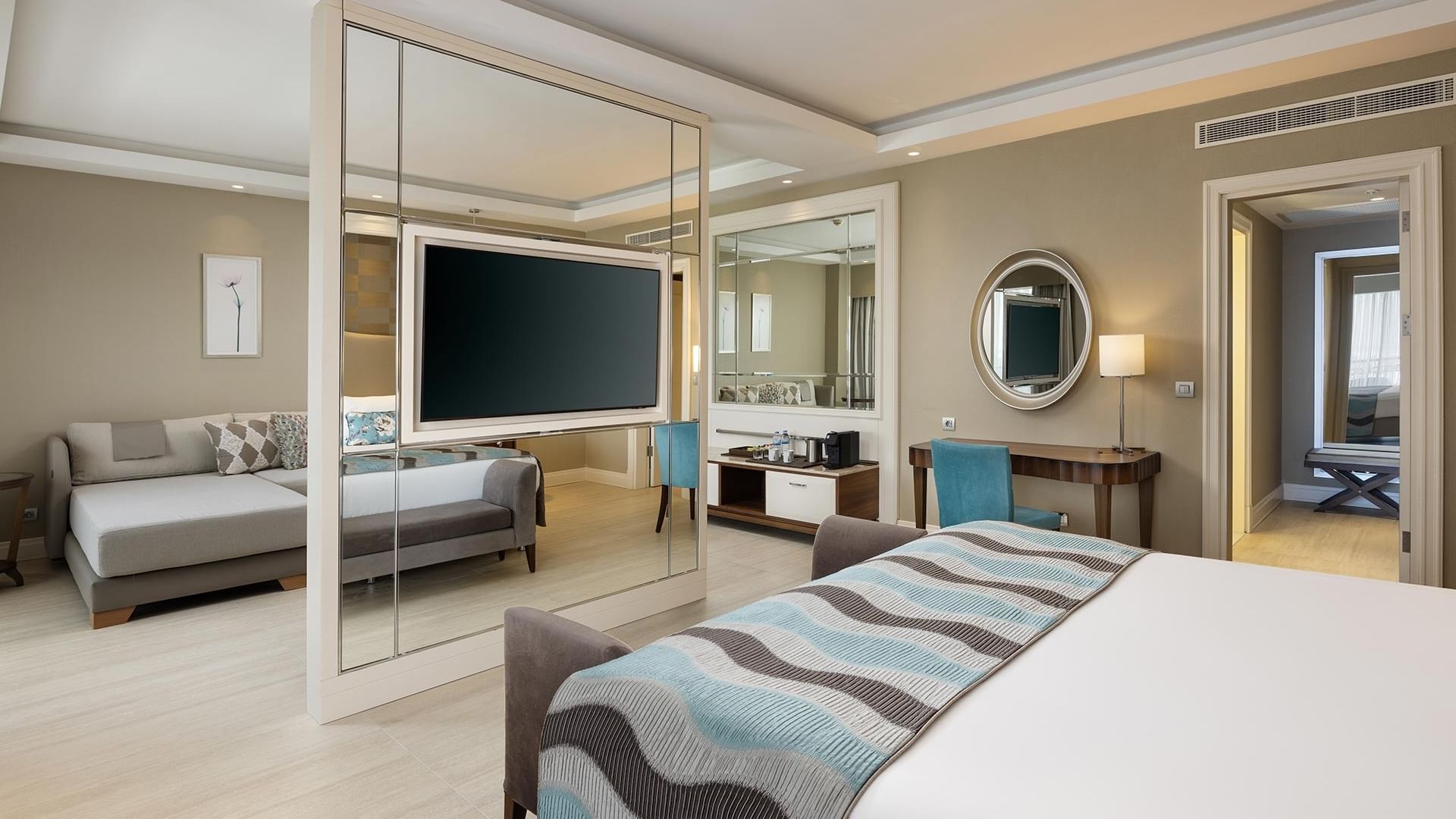 Elegant Deluxe Room with large bed, modern decor, and spacious layout at Titanic Deluxe Golf Belek in Antalya.