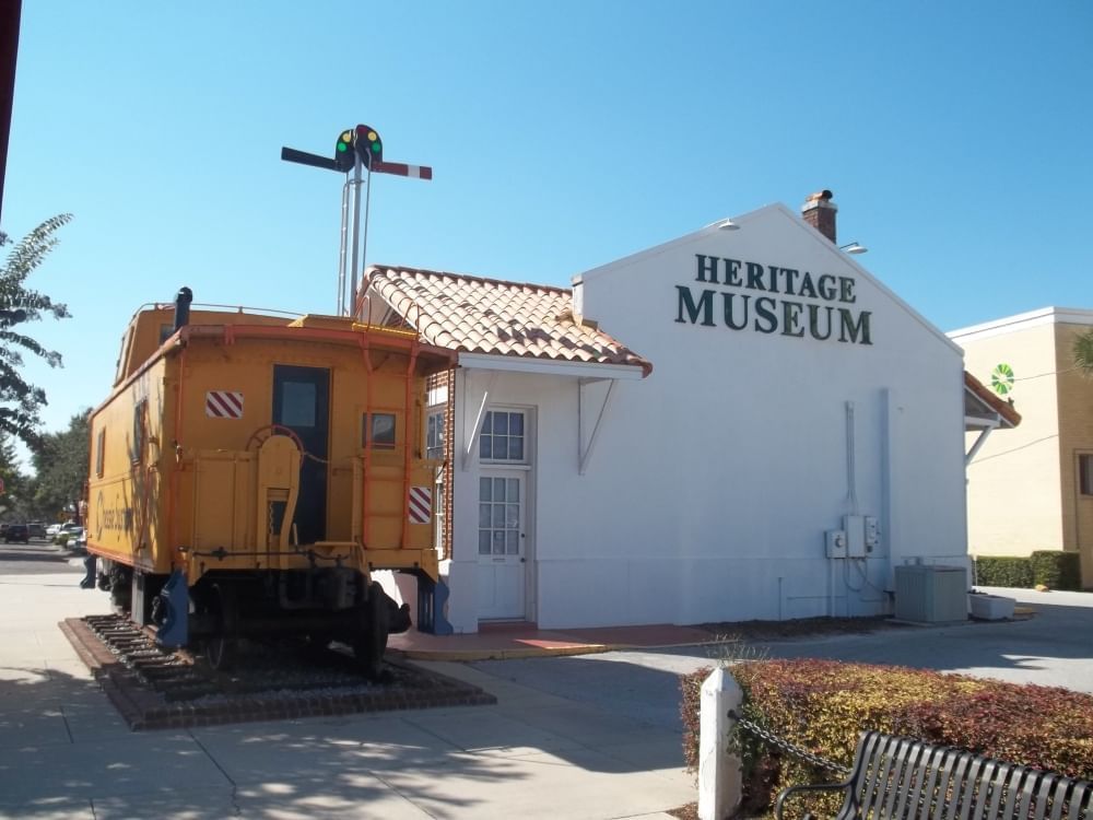 A building with the words "HERITAGE MUSEUM" surrounded by a clear blue sky.