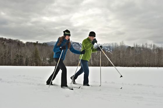 A couple skiing near Topnotch Stowe Resort