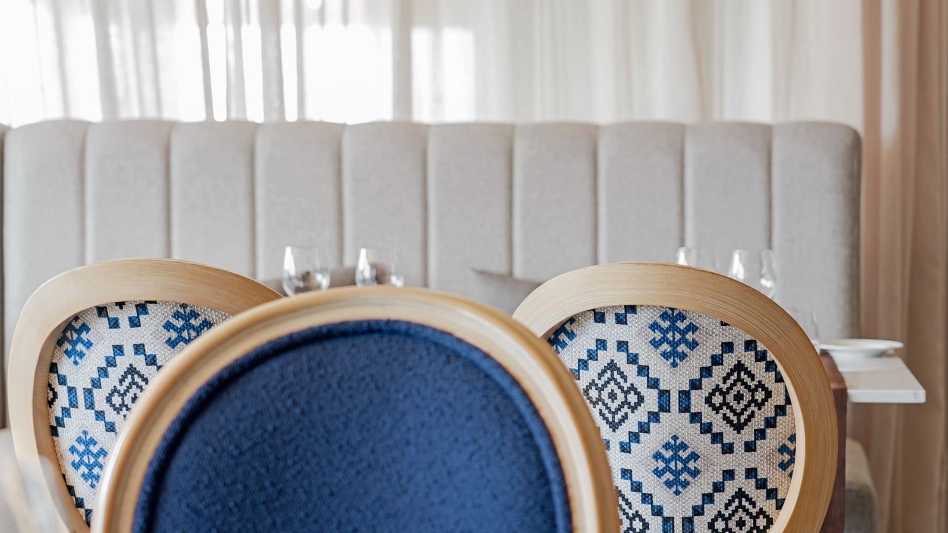 Close-up of chairs with a blue pattern in Monte Brasil Restaurant's at Terceira Mar Hotel