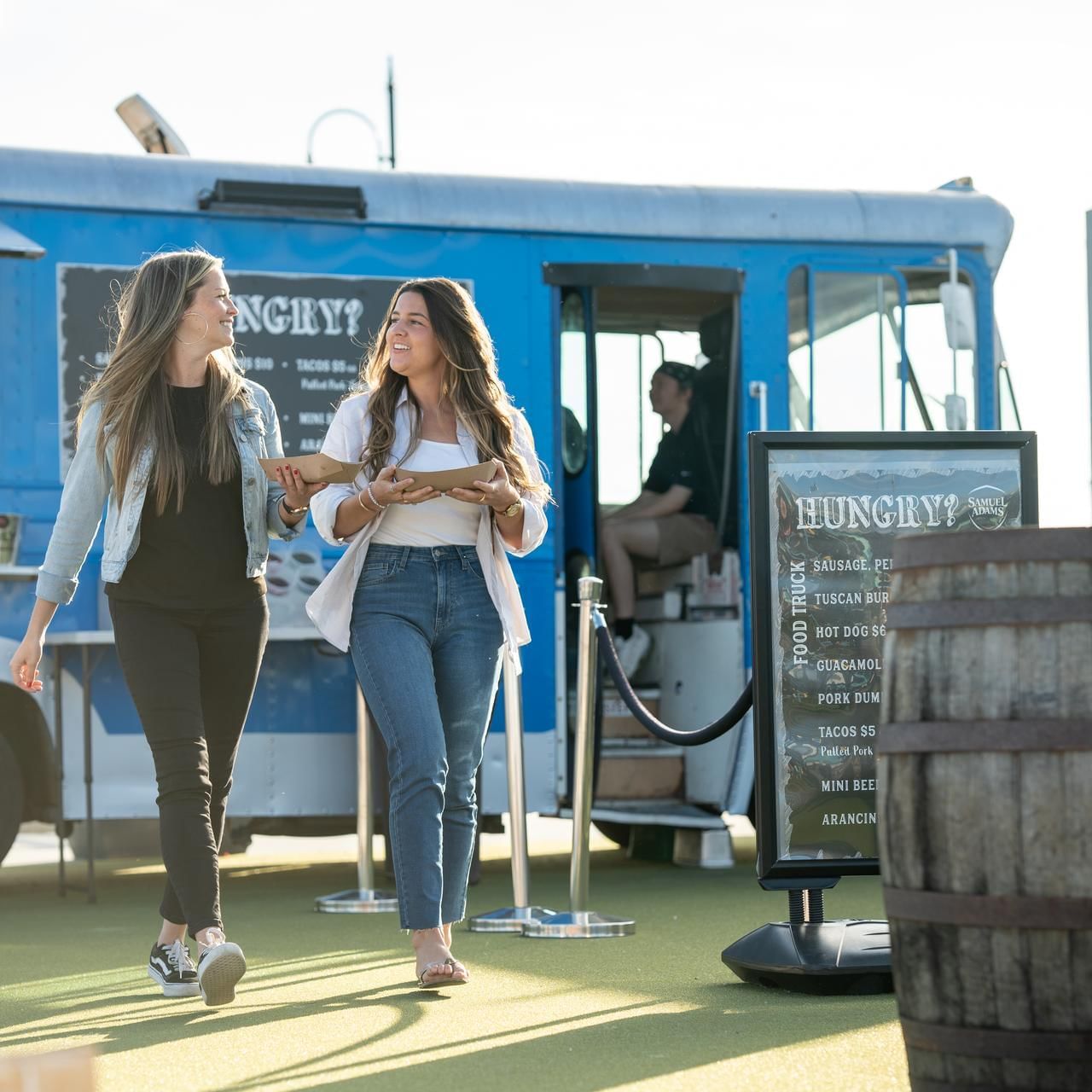 Two ladies buying food from a truck in Beer Garden at The Artisan Hotel at Tuscan Village