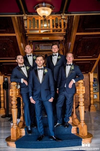 Groom & groomsmen posing on stairs at Horton Grand Hotel