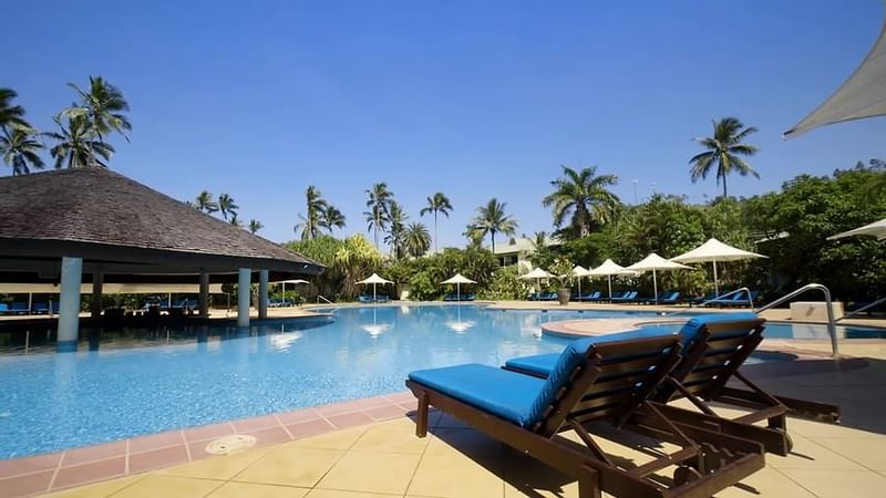Lounge chairs by the swimming pool at The Naviti Resort