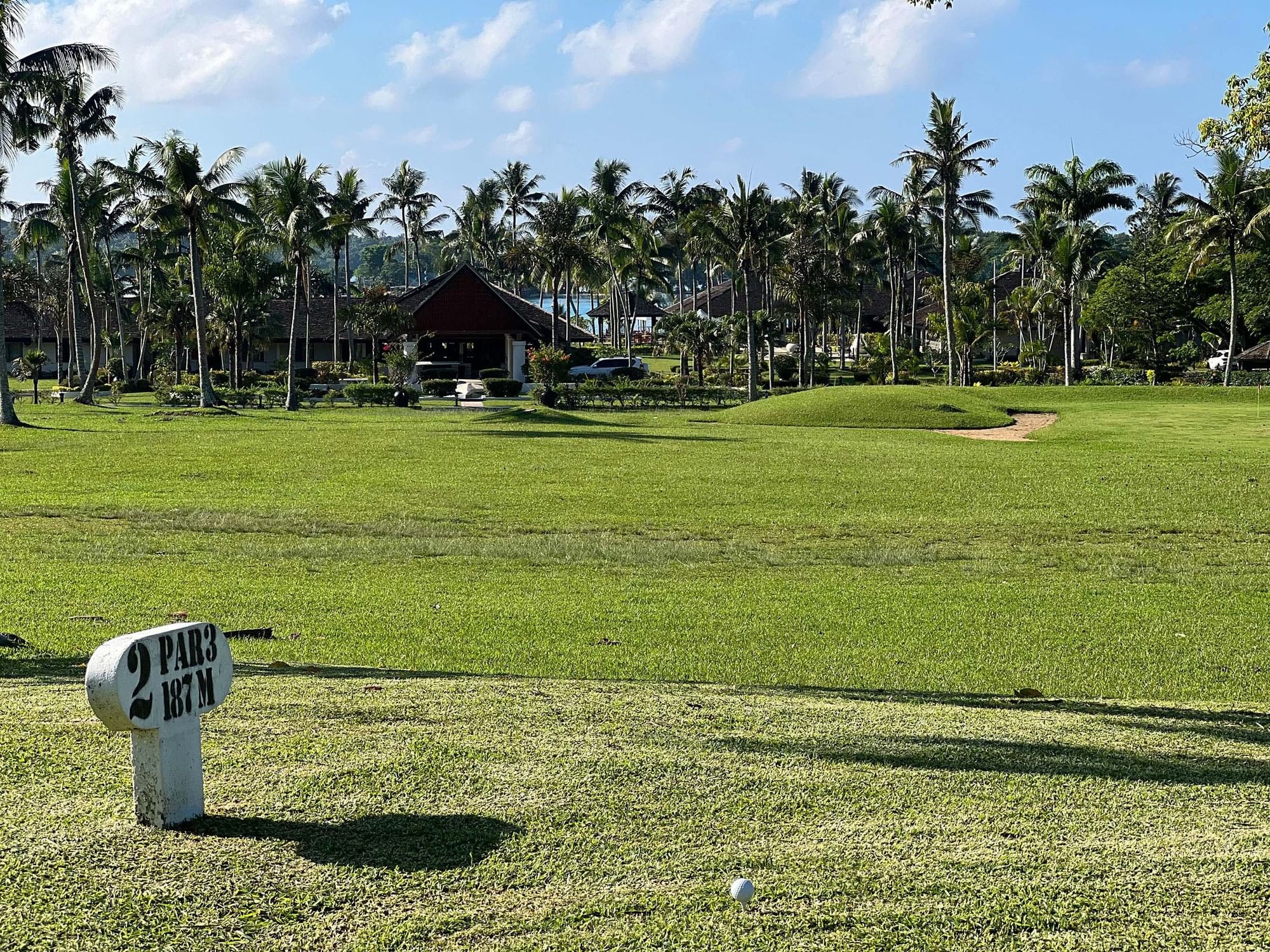 Golf course fairway with palm trees and a sign indicating 2 Par 3 at Warwick Le Lagon Vanuatu.