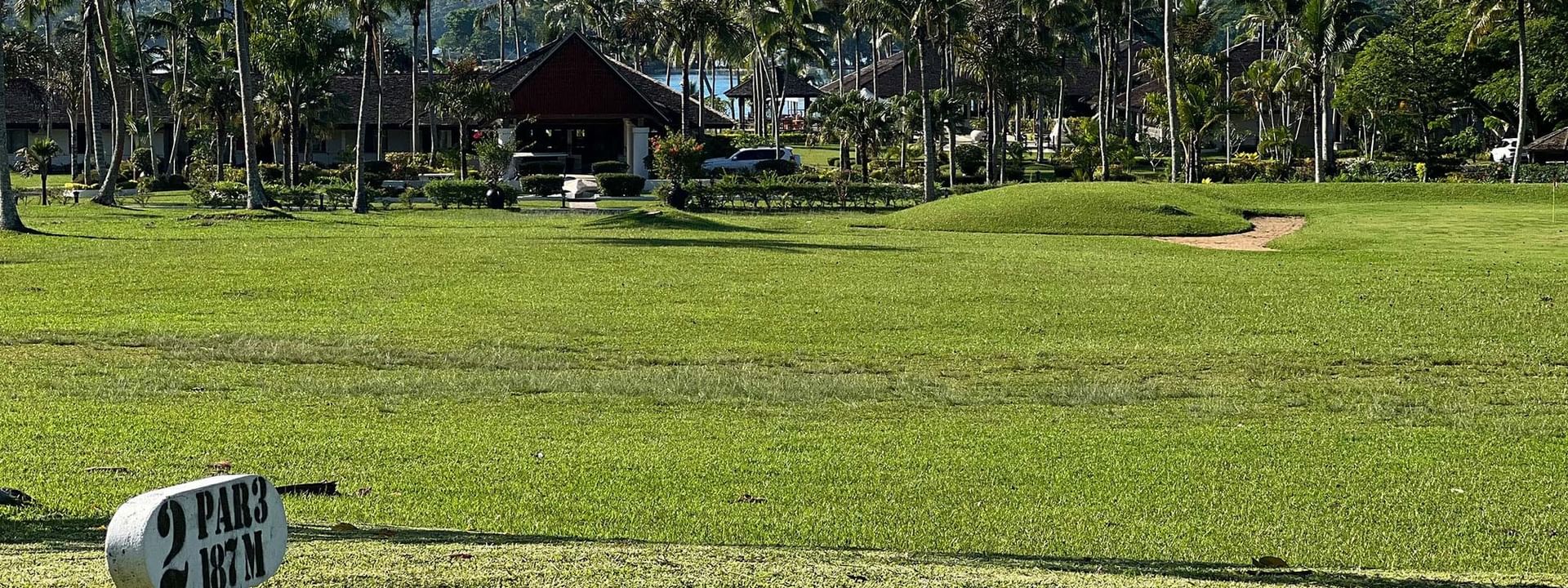 Golf course view with lush green field and palm trees at Warwick Le Lagon - Vanuatu, Efate