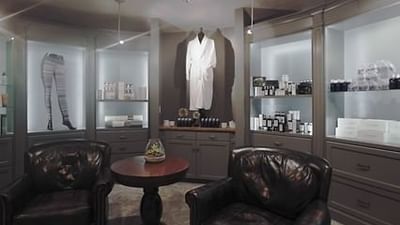 Spa interior with cozy seating, a skincare shelf, and a white robe display at Hotel Park City Autograph Collection