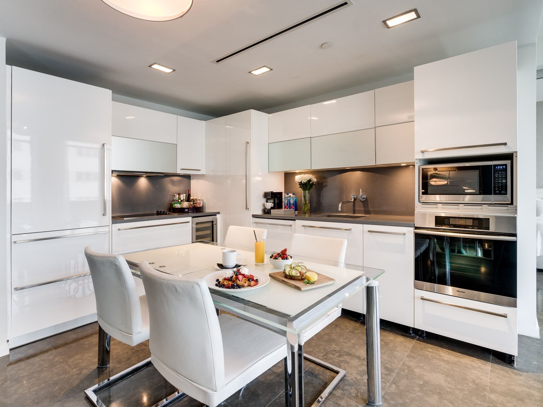 kitchen with white cabinets and white dining table