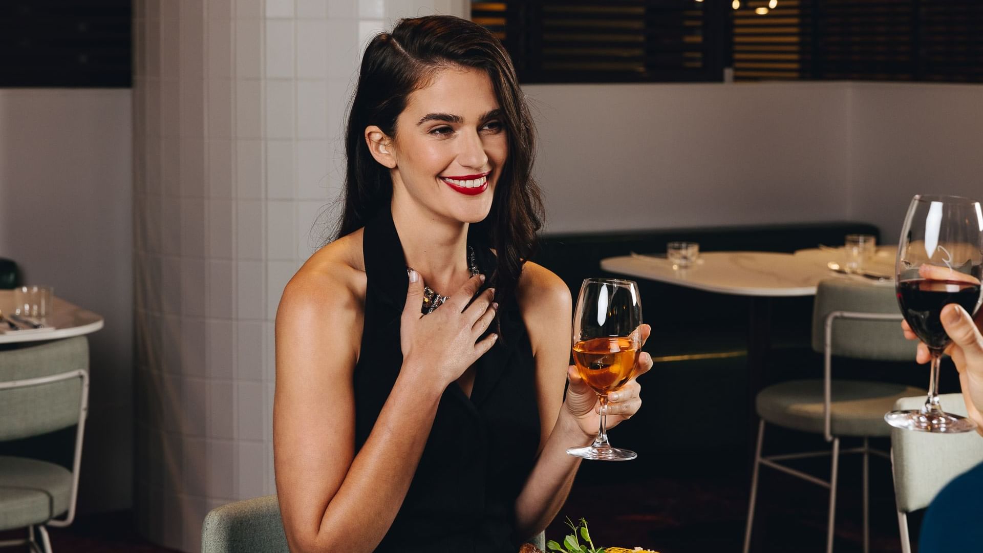Lady having wine at Eva's restaurant at Pullman Melbourne City