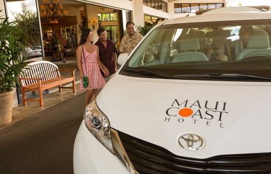 Shuttle with guests at the entrance of Maui Coast Hotel