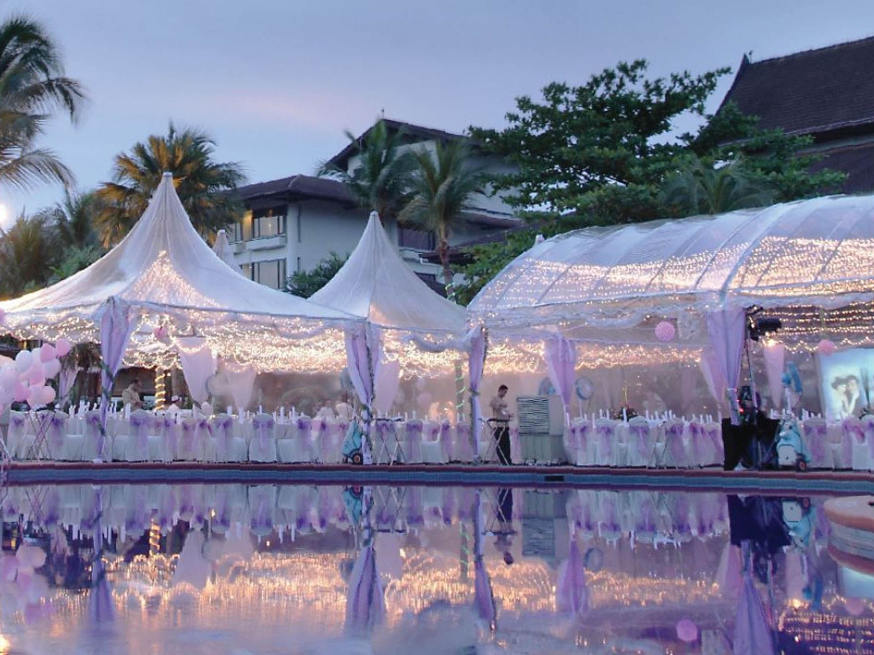 Exterior view of the Poolside Soiree arranged with white & lavender chairs for an event at Saujana Hotel Kuala Lumpur