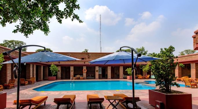 Sun beds by the hotel pool at Faisalabad Serena Hotel