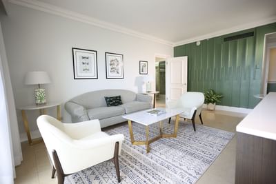 Spacious living area with cozy couches in One Bedroom Suite at Courtleigh Hotel & Suites