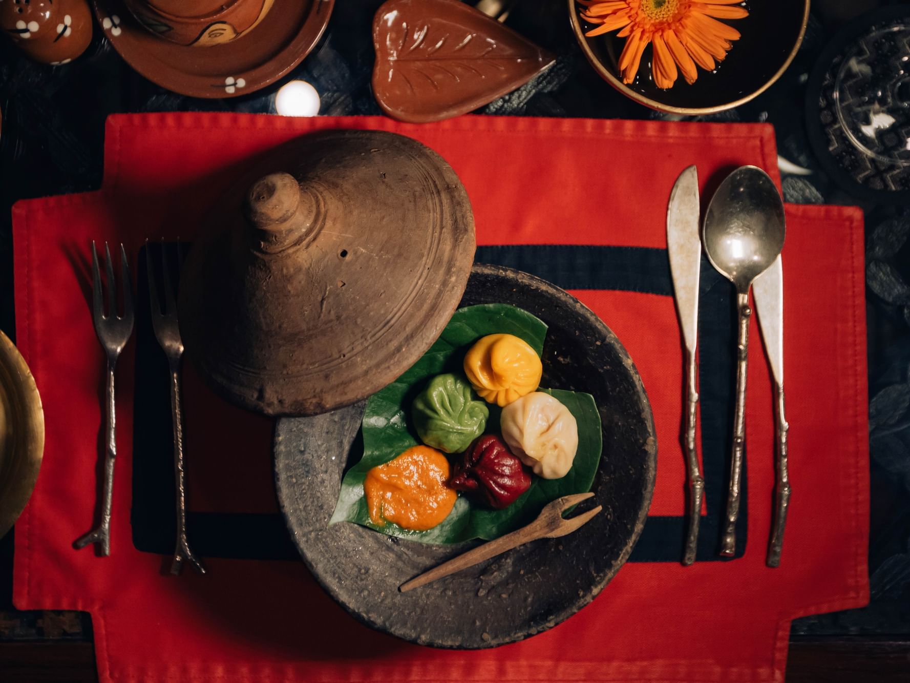Colorful dumplings on a leaf in a stone bowl in Krishnarpan Restaurant at Dwarika's Hotel Kathmandu