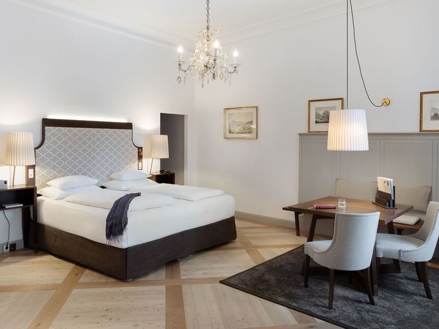 Junior Suite bedroom with a tufted bed in Schloss Hotel